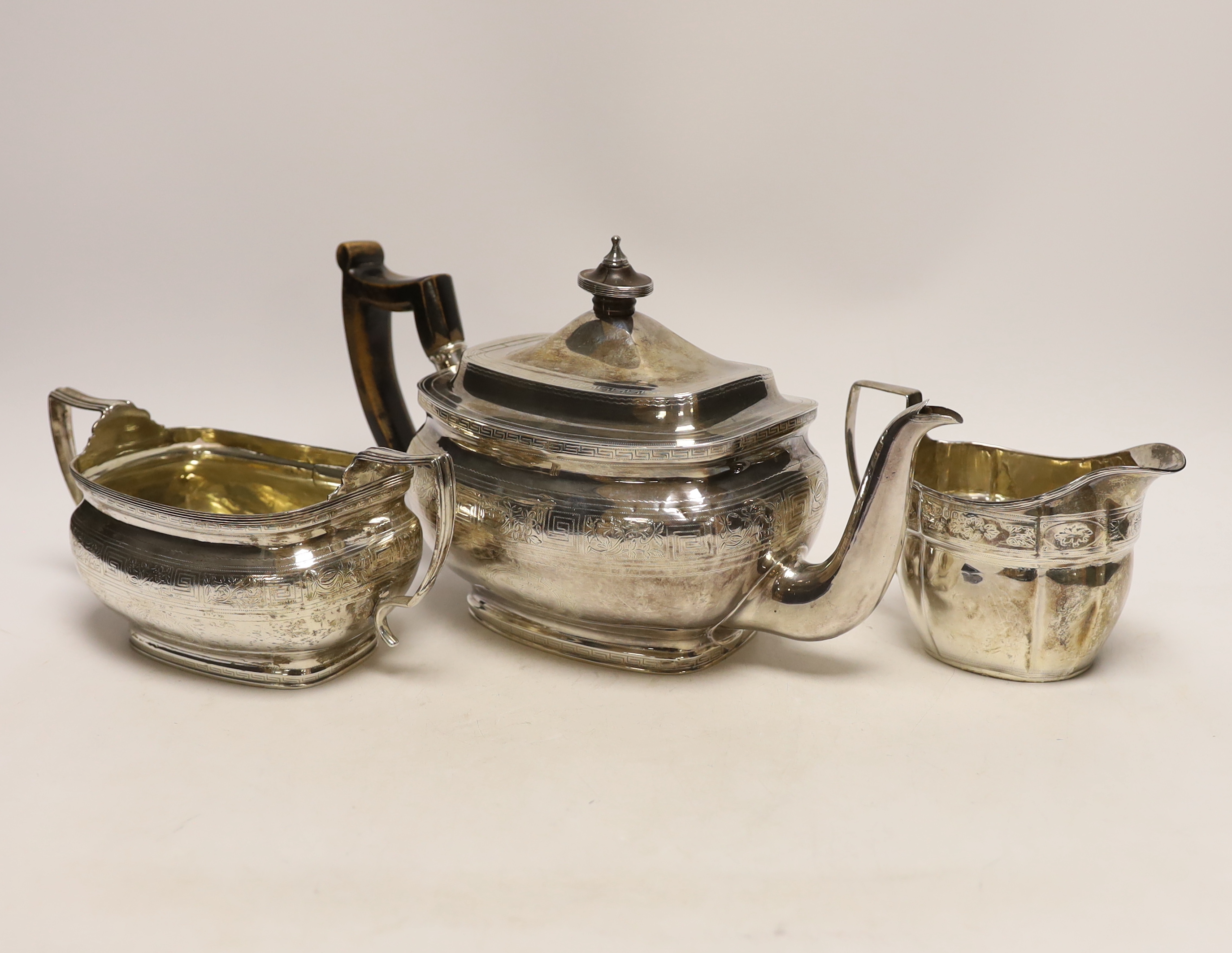 A George III engraved silver teapot and sugar bowl, by Andrew Fogelberg, London, 1805 and a similar matched silver cream jug, maker's mark rubbed, London, 1806